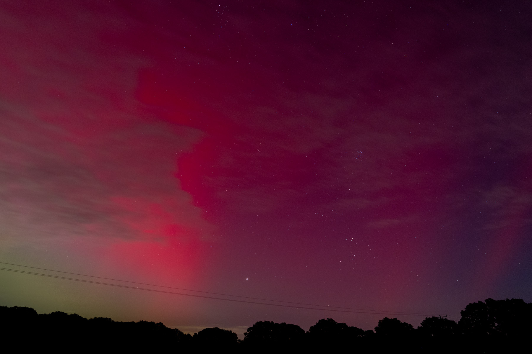 Jupiter rising behind the aurora